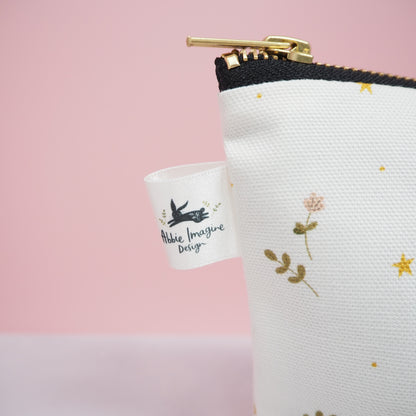 Close up of label on Moons and stars cosmetic bag by Abbie Imagine